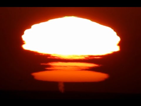 Rare and unusual (The Novaya Zemlya effect) sunset mirage with green flashes and whales spouts