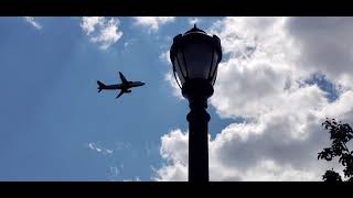 MBTA Blue Line outbound behind Logan International Airport as plane takes off from Runway 33L