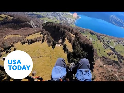 Brave parachuter weaves through a narrow canyon in Switzerland | USA TODAY