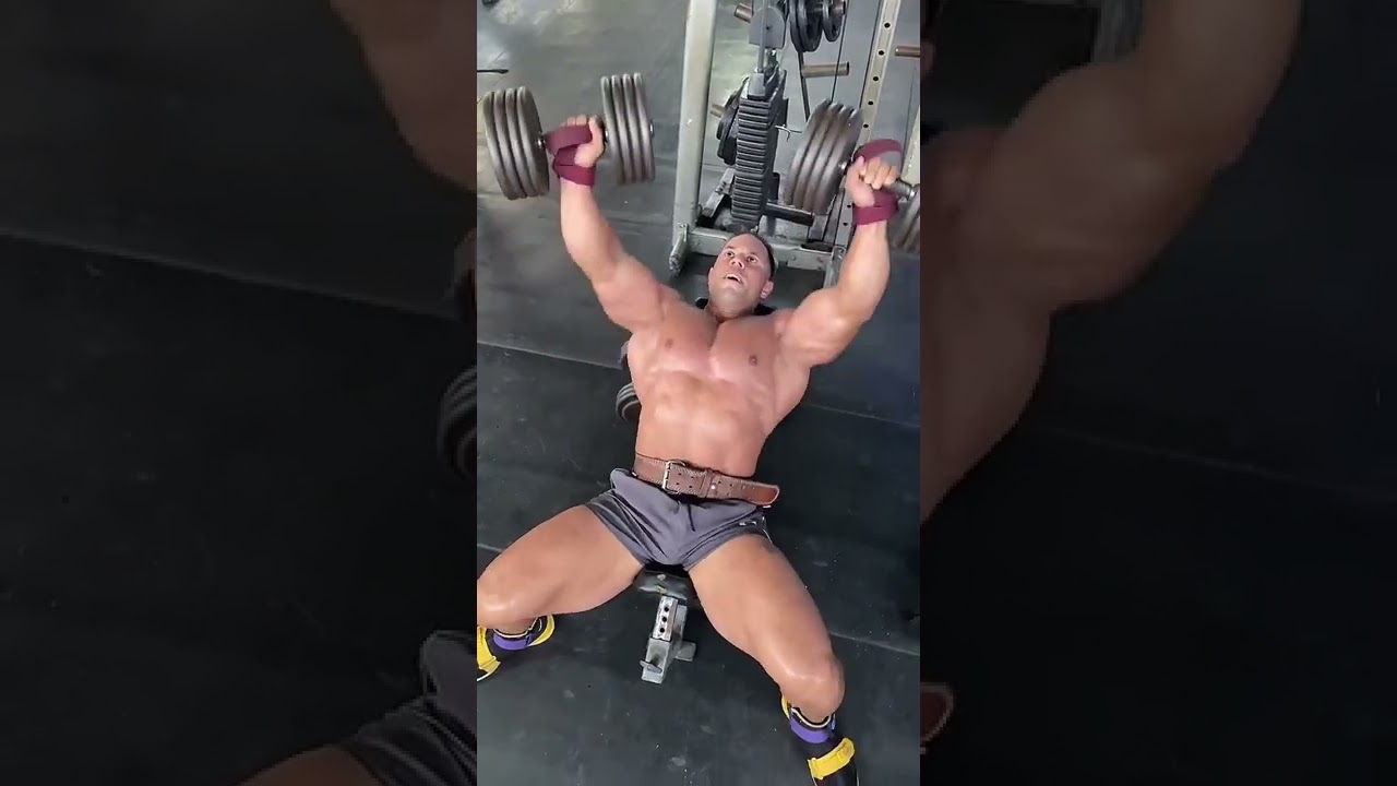 giant-shirtless-muscle-bull-in-short-workout-shorts-lifting-weights