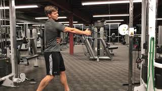 Standing twisting cable high row