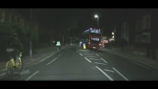 Double decker bus overtakes cyclists.
