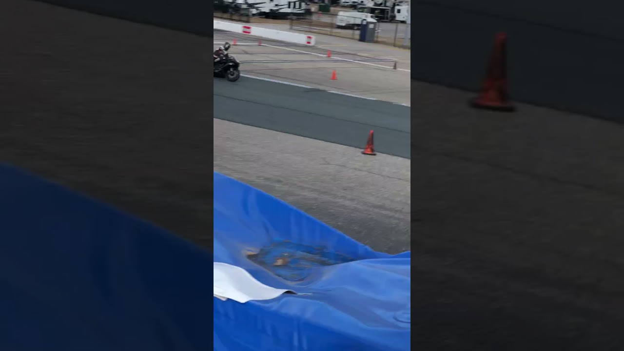 Guy flips forward during motorcycle race around track