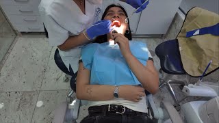 Dentist Exng Teeth Of Female Patient