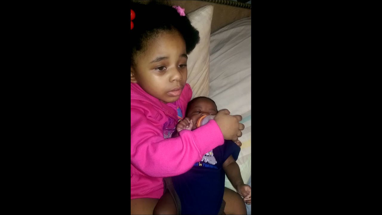 Big sister feeding baby brother - YouTube