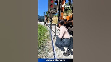 Post installation machine: people installing posts with a machine