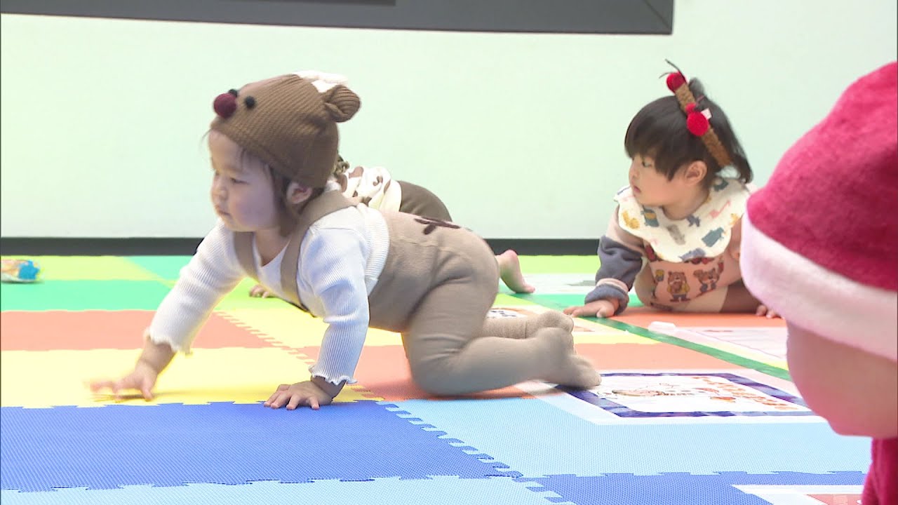 Babies compete in a crawling race dressed as Santas and reindeer