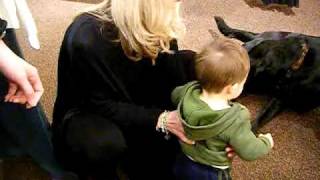 Drew and a big black dog kiss on the lips!