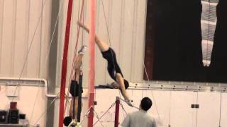 Elijah practicing hop half turn on high bar