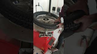 Changing a new bike tyre on tyre changer machine
