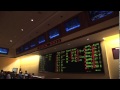 Sportsbook in Las Vegas with Gamblers Watching Live Sporting and Horse Racing Competitions on Screen