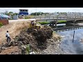Incredible nice build road landfill operator bulldozer clearing dirt  truck unloading dirt in water