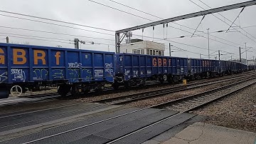 GBRf 66782 with a rake of GBRf JNAs passes through cremorne lane crossing on 27/11/25