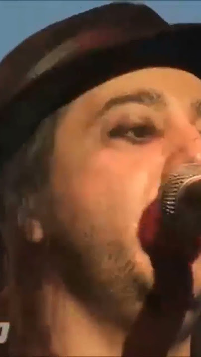 Serj Tankian gets a hug by a fan during a System of a Down show