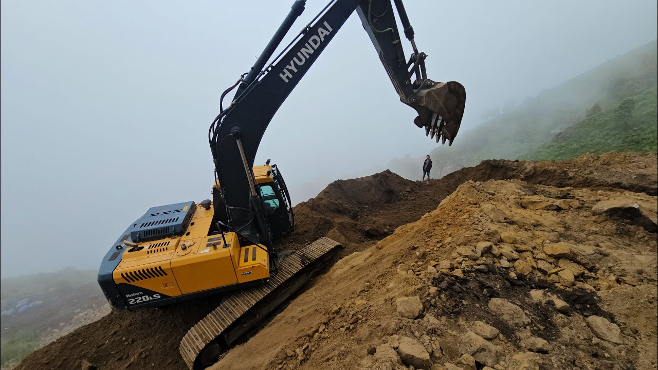 Skilled Operator Works on Dangerous Mountain Road | Excavator Clears Stones and Mud Efficiently