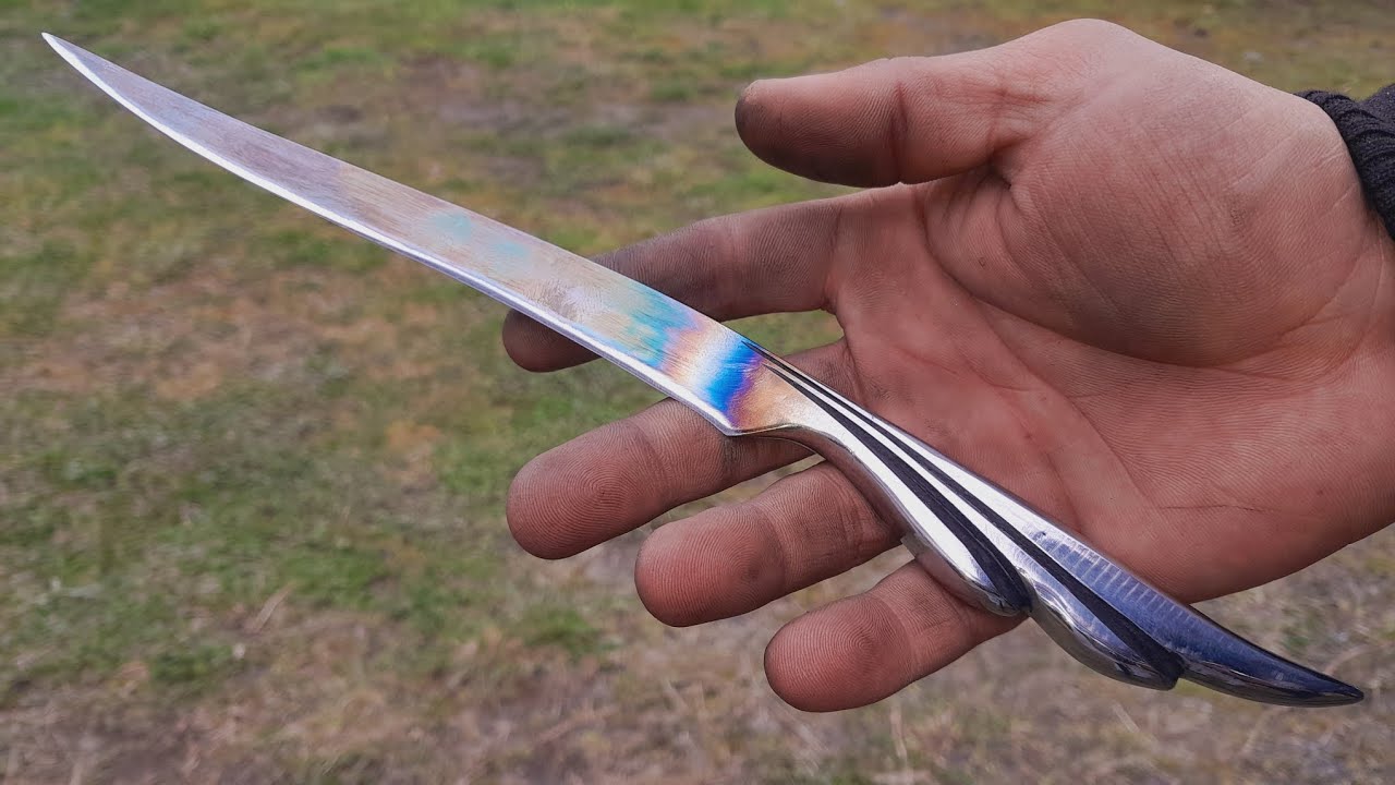forging knife with handle in the shape of a wing . 100% handmade