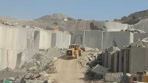 cat 988h wheel loader carry huge blocks of granite from and 200 meter deep underground quarry ongole