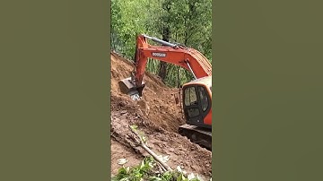 Unearthing Progress: Excavator Unleashes Power in Mountain Village for Road Construction