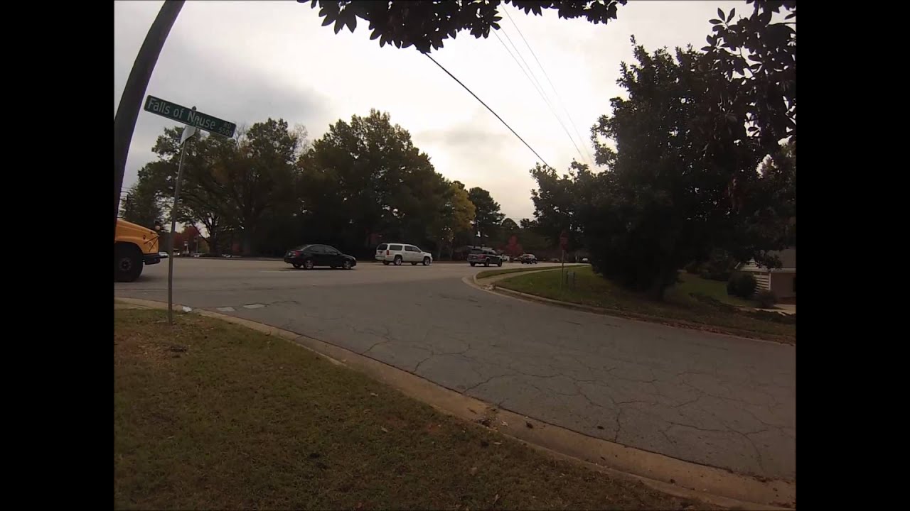 2 cars pass a stopped school bus and Raleigh Police Department give ...