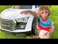 Baby monkey Bon Bon drives a car with his puppy in the garden