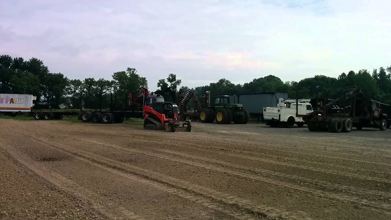 Kubota SVL90 with a power rake - YouTube