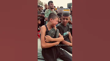 Palestinian Boy Holds Shoes Of Killed Father AJshorts 