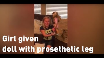 Tears of joy for girl given doll with prosthetic leg just like her