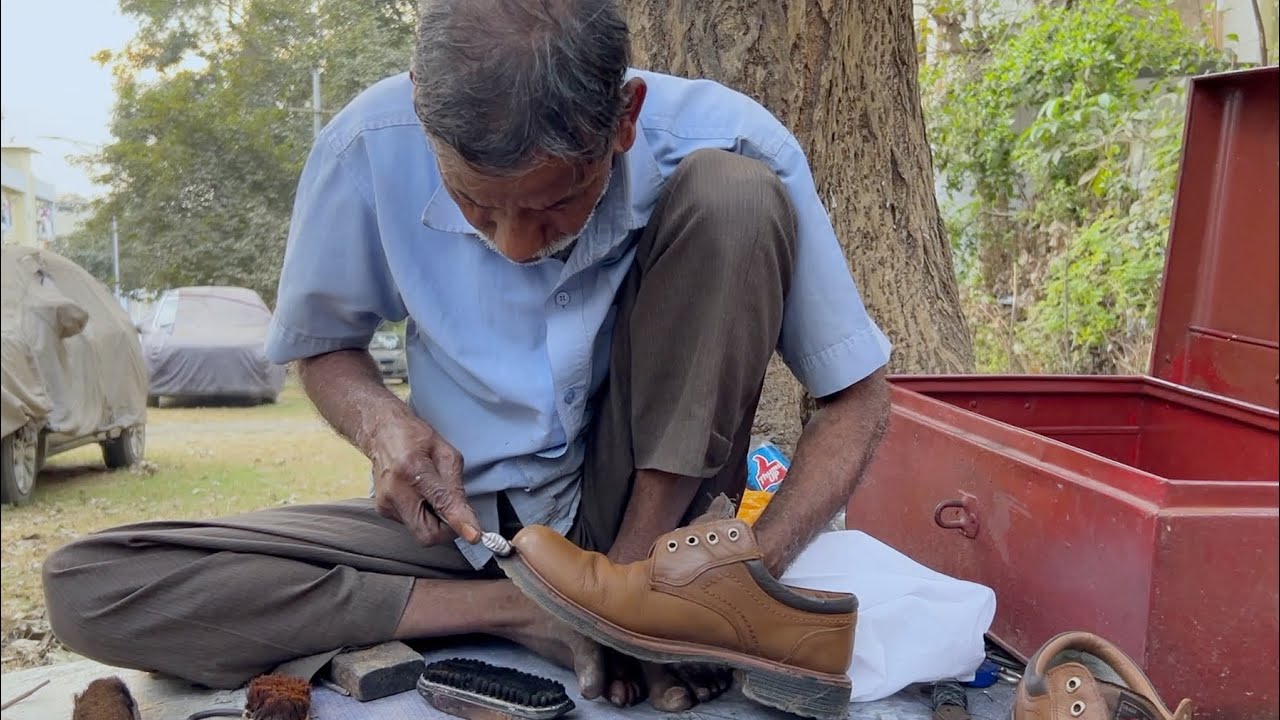 Indian Cobbler Shoe Shines at open street shop - Brown boot transformation