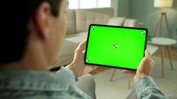 Man using green screen tablet in neutral living room | GreenScreen | Free to use | No Copyright | HD
