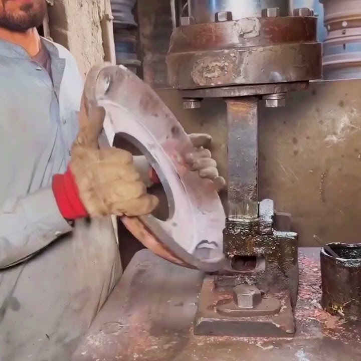 Metal Transformation: Rusted Iron Sheet into a Massive Truck Wheel Rim