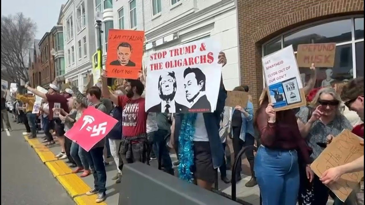 Protesters rally outside Tesla showroom in Washington | AFP - YouTube