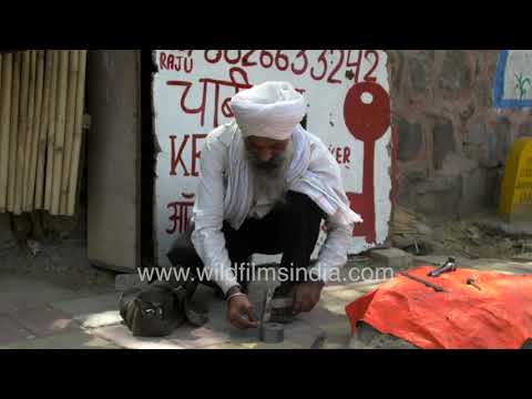 A traditional Chabi Wala shapes keys by hand at a Delhi roadside workshop