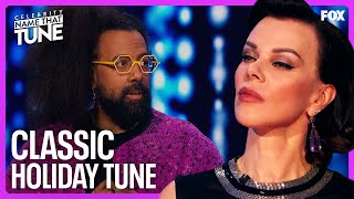 Do Reggie Watts & Debi Mazar Know Their Christmas Classics? | Celebrity Name That Tune Profile