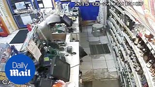 CCTV shows two men burst into corner shop with MACHETE - Daily Mail