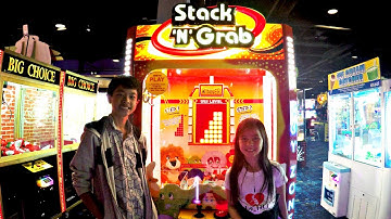 Kids Winning Prizes Playing Claw Machine Arcade Game!