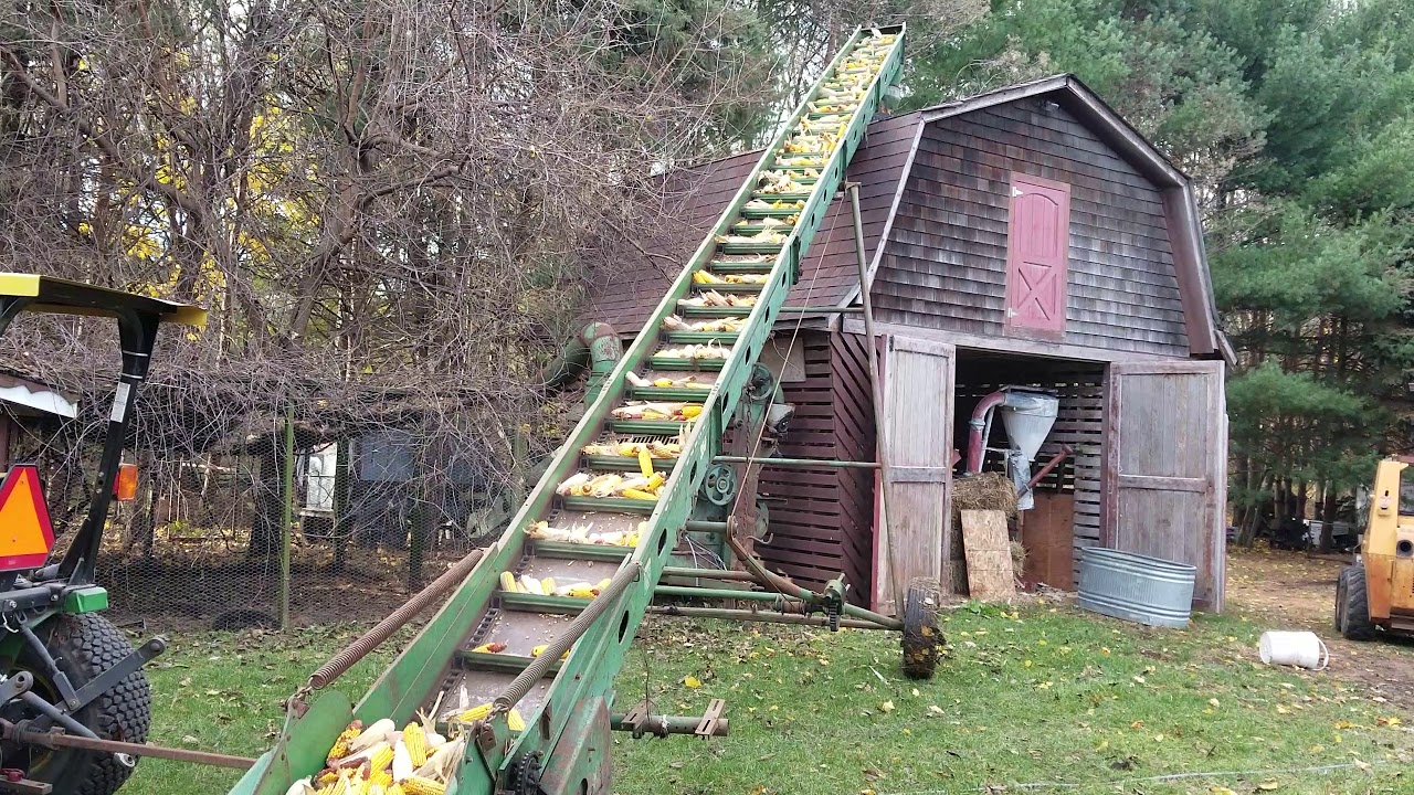 Filling the corn crib with John Deere elevator YouTube