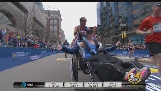 Bobby Carpenter Helps Denna Laing Cross Boston Marathon Finish-Line