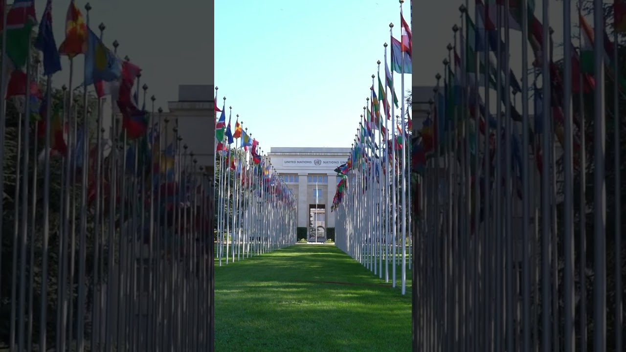 Geneva United Nations palace Palais des Nations with flags waving.