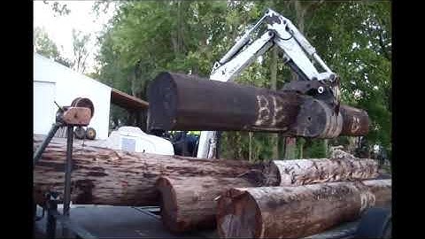 Tipping Excavator.  Moving Logs to Sawmill with Bobcat 331