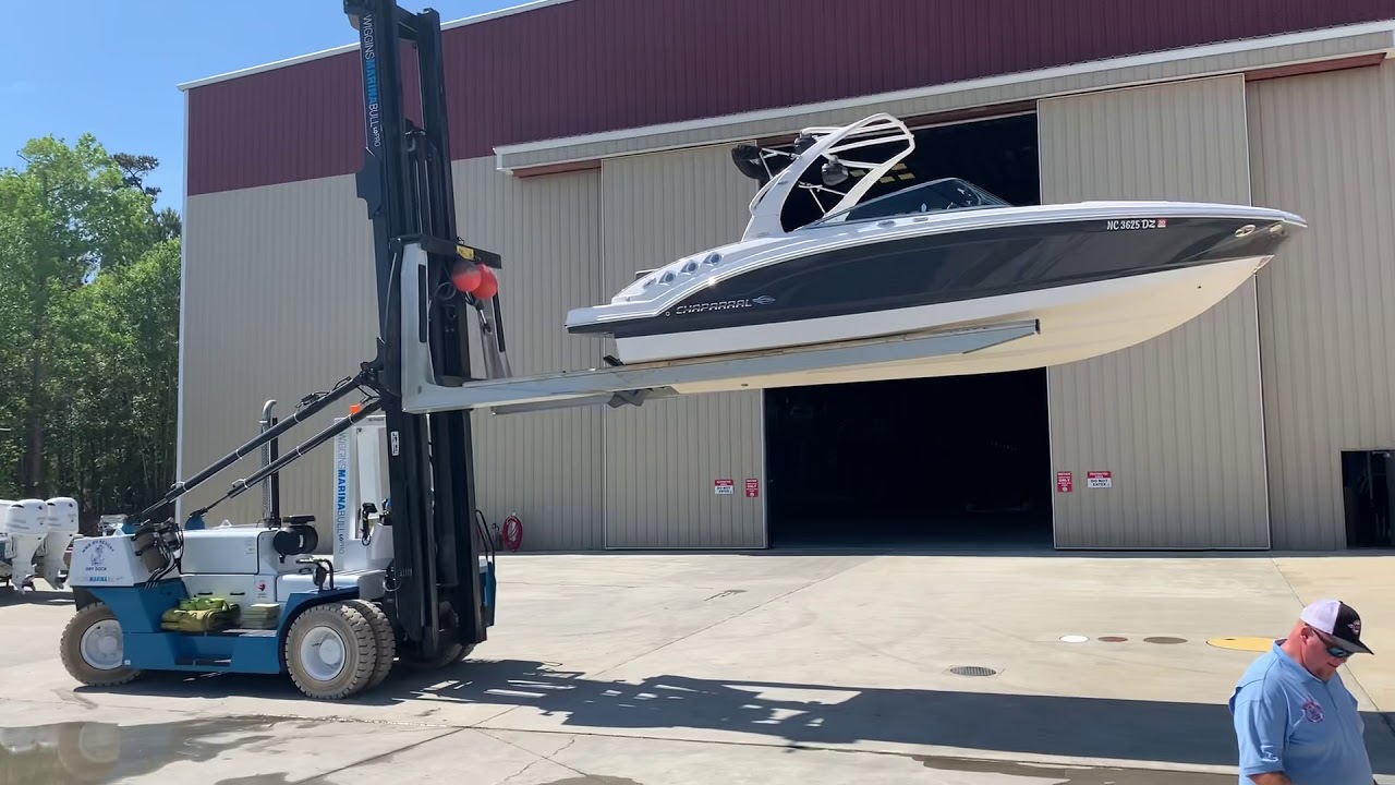 Lowering a Dry Docked Boat in to the water from a huge Forklift
