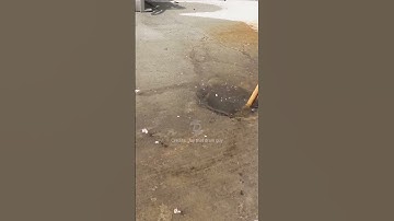 Unclogging a blocked outside drain with a bamboo plunger