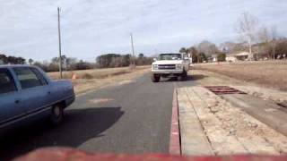 big truck towing redneck style dump truck.MPG