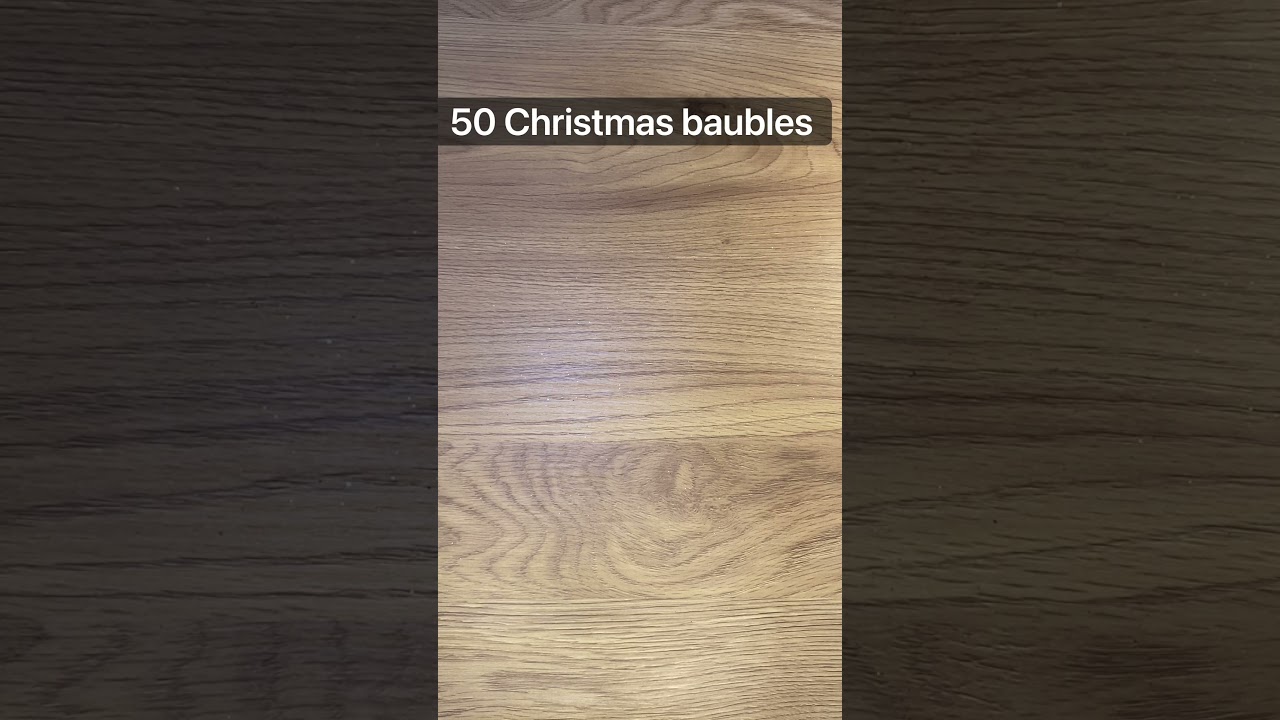 Dropping Christmas Baubles On The Table 