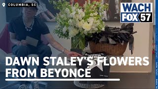 Dawn Staley receives flowers from Beyoncé