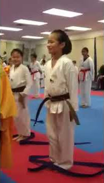 Mikayla receiving her Brown belt
