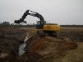 Deere Excavator Cleaning Out Drainage Ditch