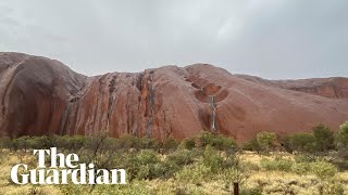 Uluru waterfalls come to life after heavy rainfall in central Australia