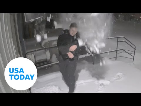 Falling snow pile catches Wisconsin police officer by surprise | USA TODAY