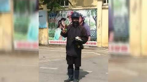 Hình ảnh người mặt đen áo đen cầm đầu gà đi xin tiền