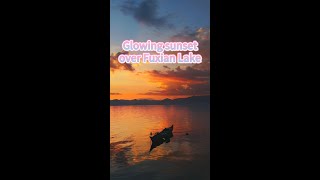 Download Lagu Glowing sunset over Fuxian Lake in Yunnan, China MP3